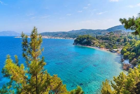 Tsamadou Beach with crystal-clear turquoise waters and dramatic cliff backdrop